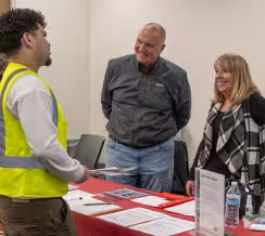 Student talking with employers at a Summit hiring fair event