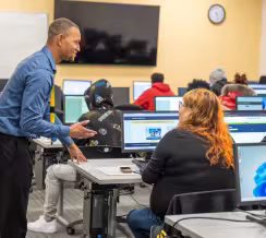 Summit Academy staff assisting Open House attendee with the online application