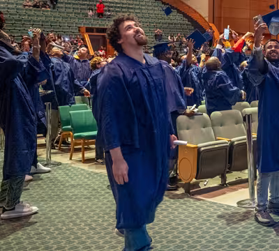 Nicholas celebrating and smiling at the end of Summit's commencement ceremony
