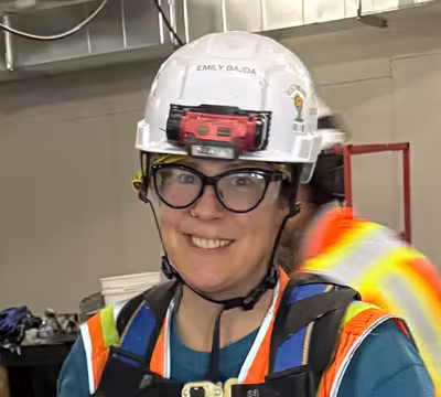 Photo of Summit Academy Alum, Emily, on the job as an electrician.