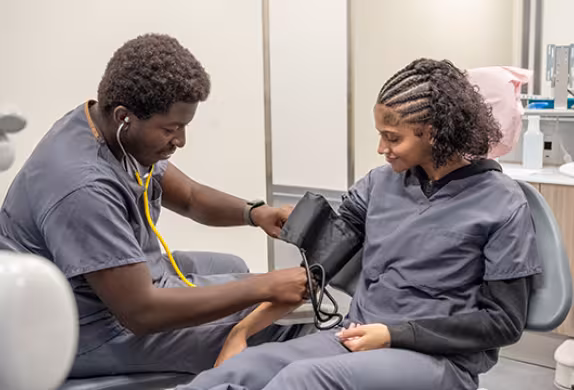 Unlicensed Dental Assistant students learning hands-on in exam room at Summit