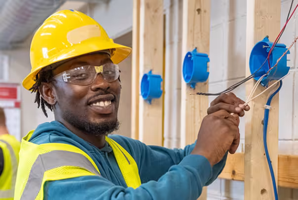 Electrician student at Summit learning wiring hands-on in the classroom