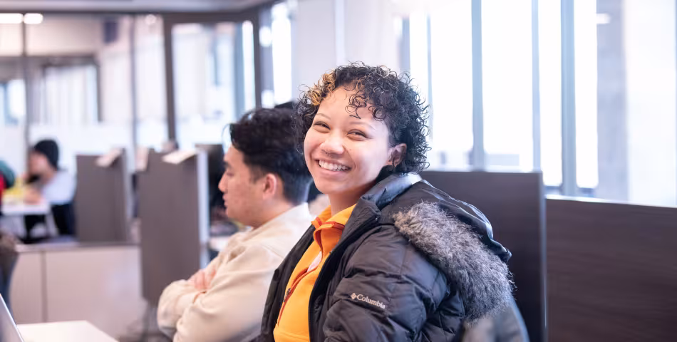 Smiling Summit Student sitting at a desk