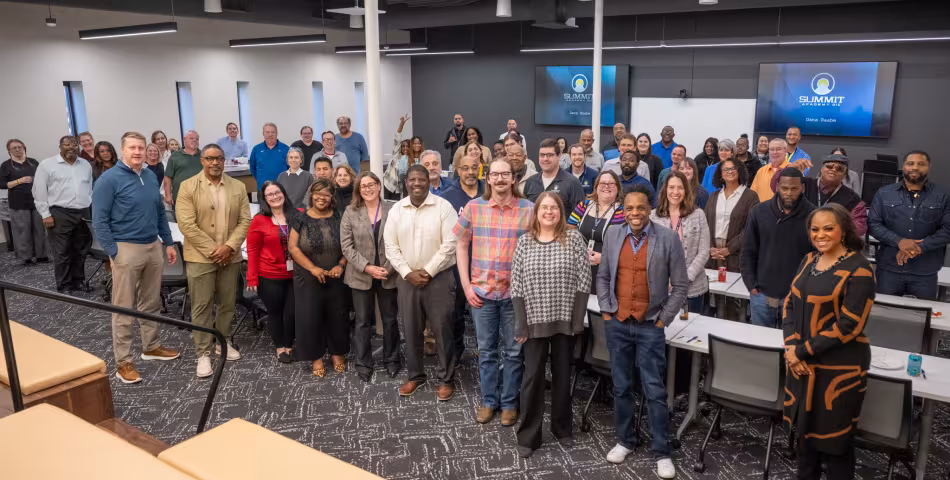 group photo of Summit Academy staff at an employee event