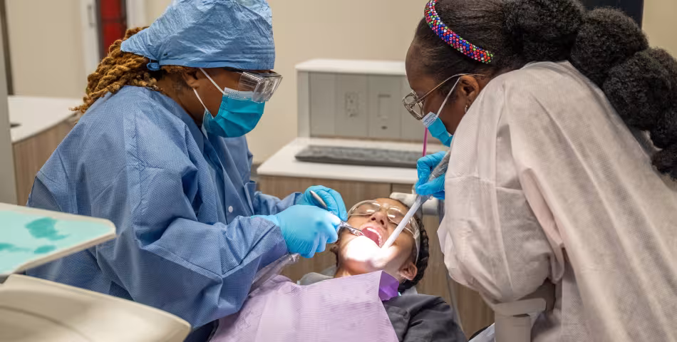 Unlicensed Dental Assistant students learning chair side in exam rooms