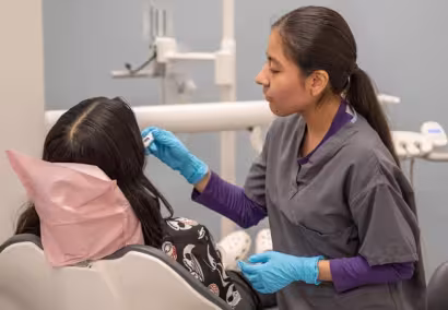 Dental students learning in exam room at Summit