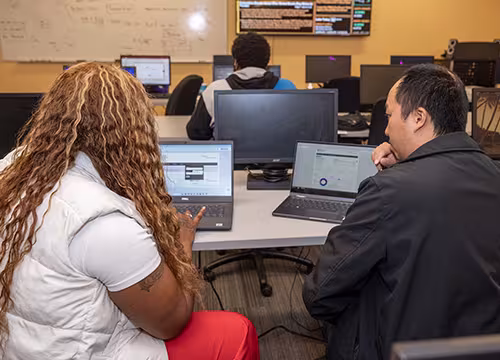students discussing projects in financial services class