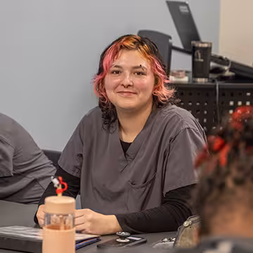 Unlicensed Dental Assistant student in classroom