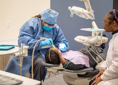 Unlicensed Dental Assistant students learning hands-on in exam room at Summit
