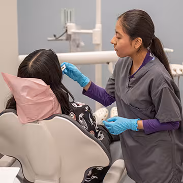 Unlicensed Dental Assistant students learning hands-on in exam room at Summit