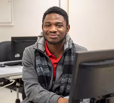Medical Administrative Assistant student in classroom looking at camera