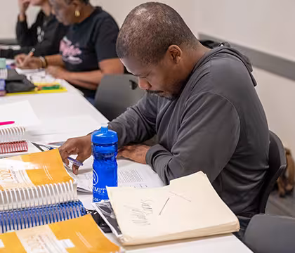 Medical Administrative Assistant student in classroom with books