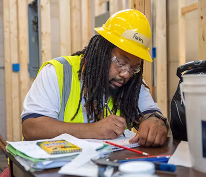 Electrician student at Summit drawing a diagram