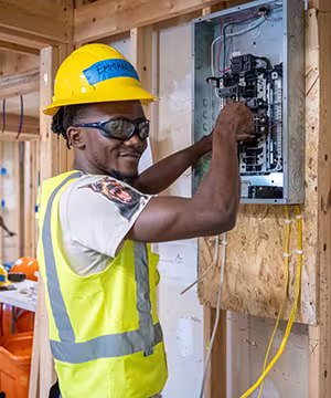 Electrician student at Summit wiring a fuse box