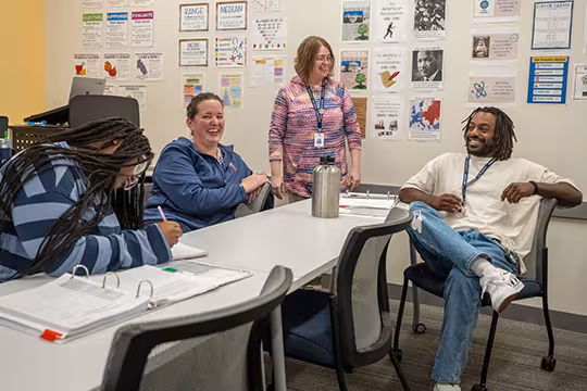 GED students and instructor in a group activity in class