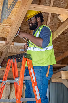 Electrician student on ladder