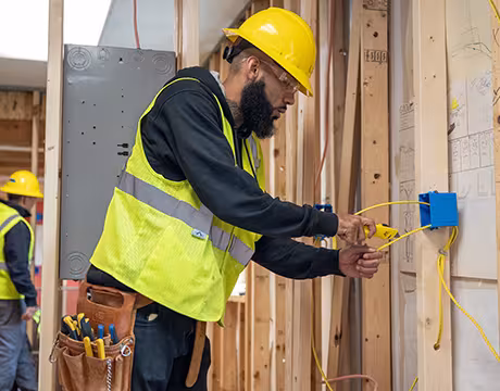 Electrician student cutting wire