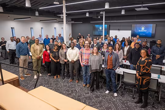 group photo of Summit Academy staff at an employee event