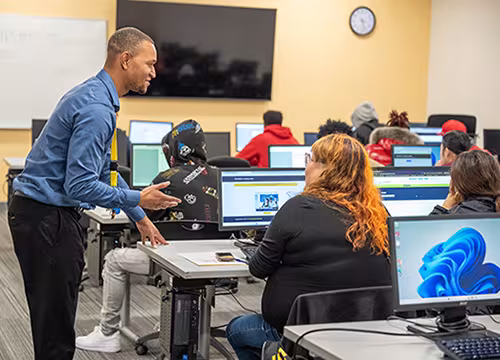 Summit staff assisting a prospective student at an enrollment open house event