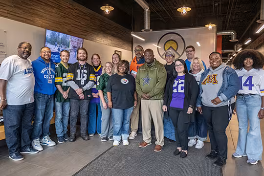 Summit staff wearing jerseys for NFL kickoff jersey day