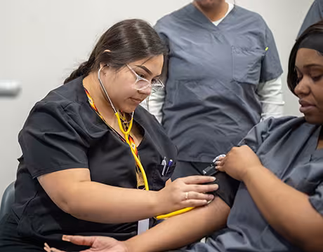 Unlicensed Dental Assistant students learning hands-on in exam room at Summit