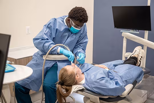 Unlicensed Dental Assistant students learning hands-on in exam room at Summit