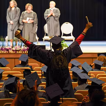 GED graduate celebrating after commencement