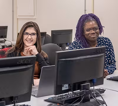 Smiling Medical Administrative Assistant students in classroom