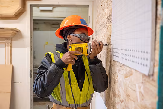 Carpentry student at Summit practicing drilling accuracy