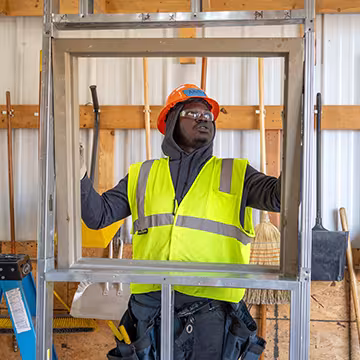 Carpentry student at Summit inserting a window frame