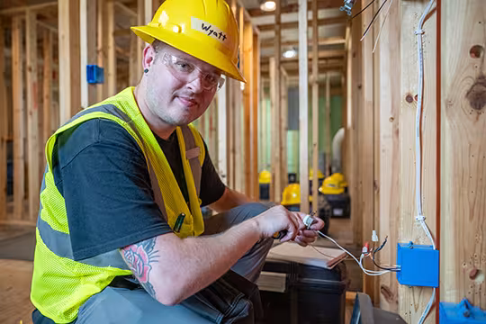 Electrician student at Summit learning wiring hands-on