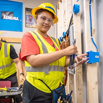 Electrician student at Summit learning wiring hands-on