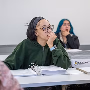 GED student listening to the instructor in class at Summit Academy