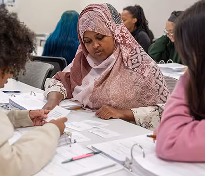 GED student reading notes in class at Summit Academy