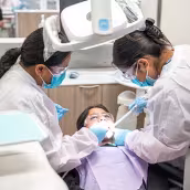 Unlicensed Dental Assistant students learning hands-on in exam room at Summit