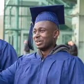 happy graduate in cap and gown